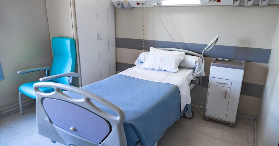 empty hospital bed inside of a rural hospital