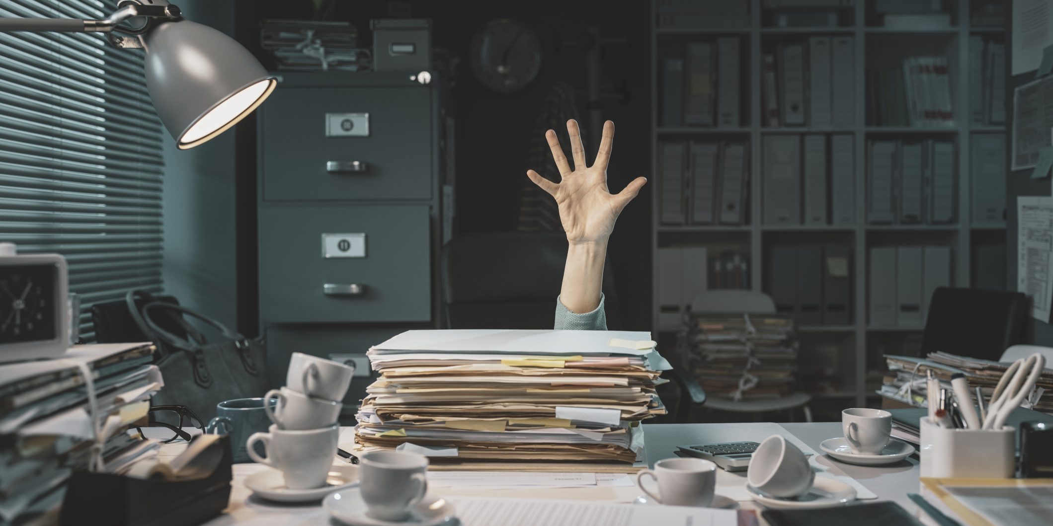 Office worker overwhelmed with paperwork